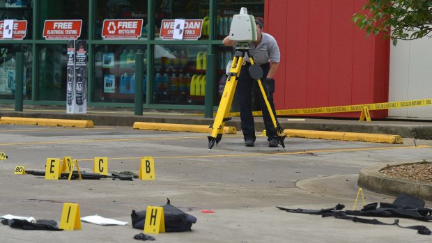 A TBI technician uses a laser mapper to document the crime scene connected to the shooting in East Tennessee.