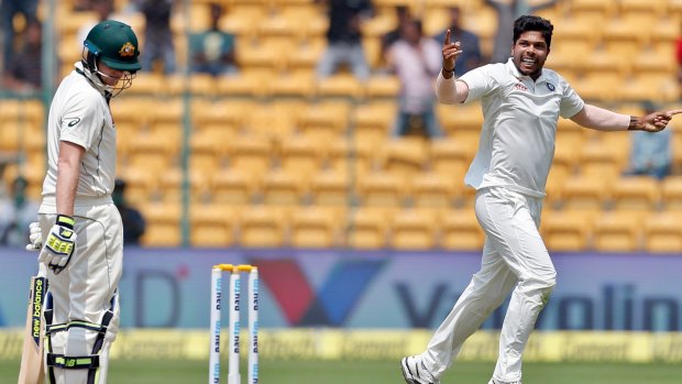India's Umesh Yadav, right, celebrates the dismissal of Australia's captain Steve Smith.
