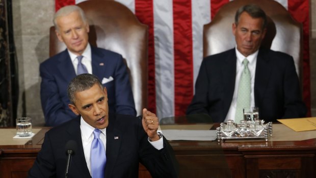 Barack Obama delivering his 2014 State of the Union address a year ago as Vice-President Joe Biden (left) and House Speaker John Boehner look on.