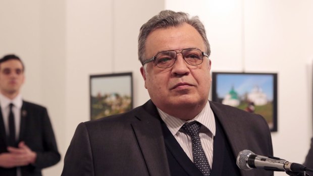 Russian Ambassador to Turkey Andrei Karlov makes an address at the gallery moments before he is shot by Mevlut Mert Altintas, seen in the background.