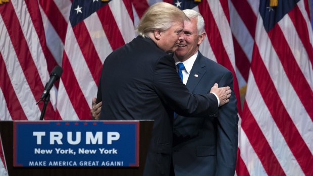 Republican presidential candidate Donald Trump, left, greets his running mate  Indiana Governor Mike Pence.