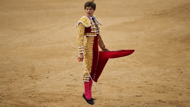 Spanish bullfighter Juan Leal jumps to call the attention of a bull during a bullfight at the Las Ventas bullring in Madrid.
