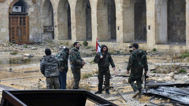 Syrian troops and pro-government gunmen inside a destroyed mosque in the old city of Aleppo on Tuesday.