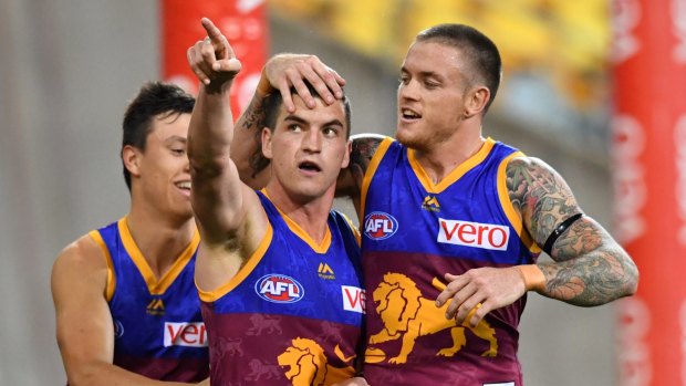 Tom Rockliff (left) celebrates kicking a goal with Claye Beams (right).
