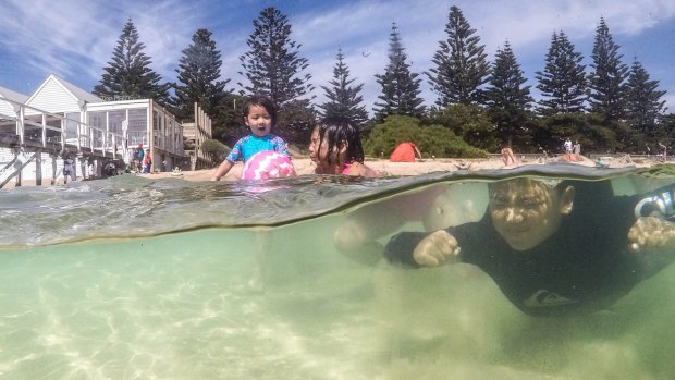 Ariana Tobotabo, 3, Aerone Tabotabo, 9, and Kat Manzo, 7, enjoy Sorrento front beach on Wednesday.