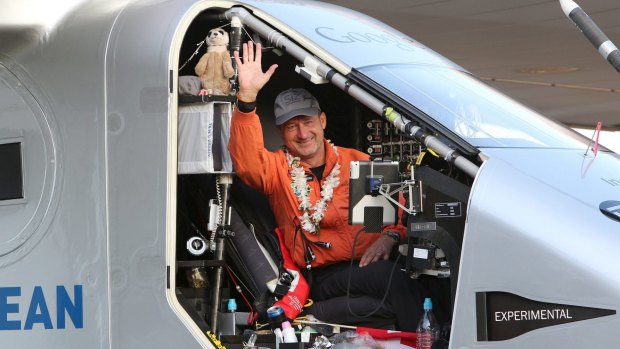 Pilot Andre Borschberg waves to the crowd after landing the Solar Impulse 2 airplane at Hawaii's Kalaeloa Airport after flying non-stop from Nagoya, Japan.
