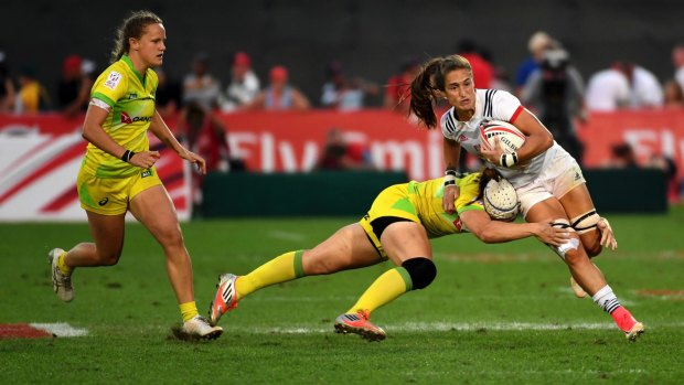 Stuck in: Ryan Carlyle of the United States is tackled by Australia's Sharni Williams.