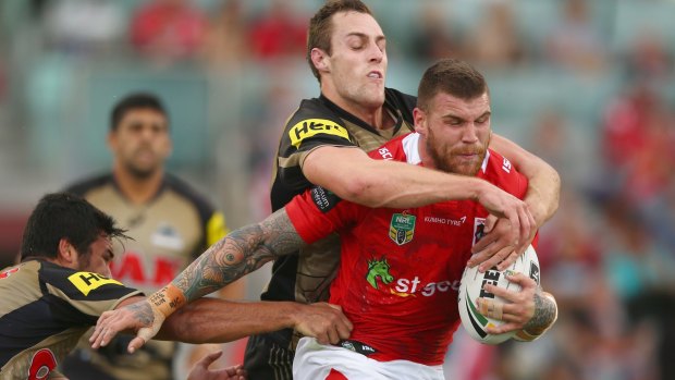 Hard man to get: Panthers defenders try to bring down Josh Dugan of the Dragons.