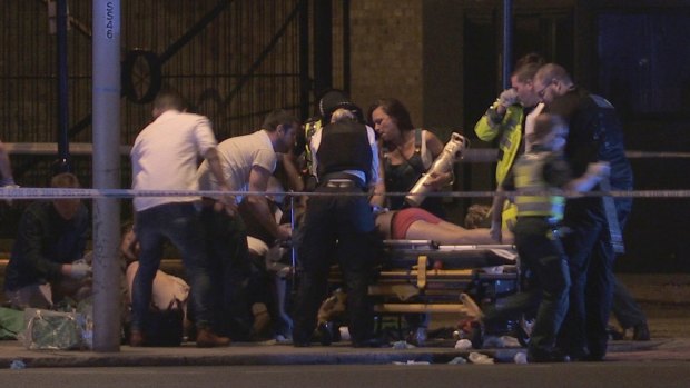People receive medical attention in Thrale Street near London Bridge.
