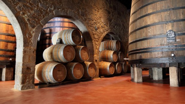 Old-fashioned Porto wine cellar with wooden barrels in Porto.