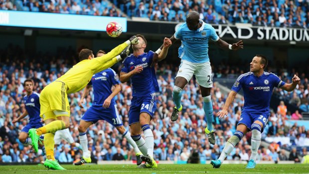 Chelsea keeper Asmir Begovic punches his teammate Gary Cahill in the face as he attempts to clear against Manchester City.