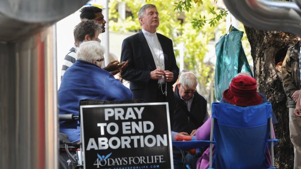 Canberra Goulburn Catholic Archbishop Christopher Prowse leads prayers during the 40 Days for Life campaign outside Civic's abortion clinic last year.