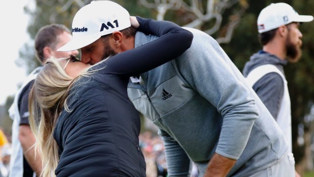 Dustin Johnson kisses his wife Paulina Gretzky after becoming the new world No.1.