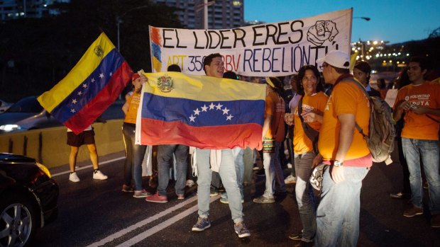 Demonstrators block traffic in Caracas on Friday.