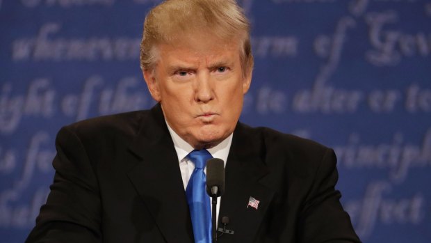 Republican presidential nominee Donald Trump listens to Democratic presidential nominee Hillary Clinton during the presidential debate.