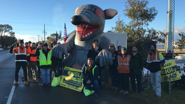 Employee anger: Unions agreed to deflate ''Scabby the Rat' at a picket line at Esso's Bass Strait operations.