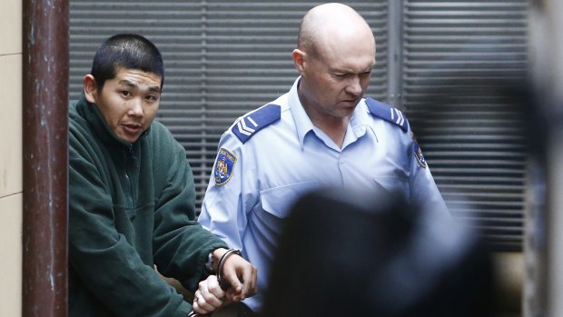 Michael Lee, ex-boyfriend of Harriet Wran, is escorted to a prison truck on Friday.