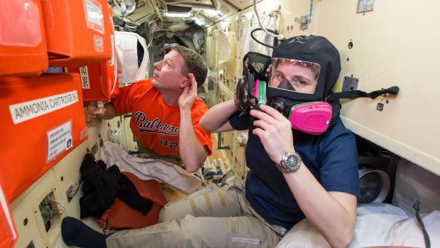 US astronaut Terry Virts, left, assists European Space Agency astronaut Samantha Cristoforetti with emergency training aboard the International Space Station during an exercise in December.