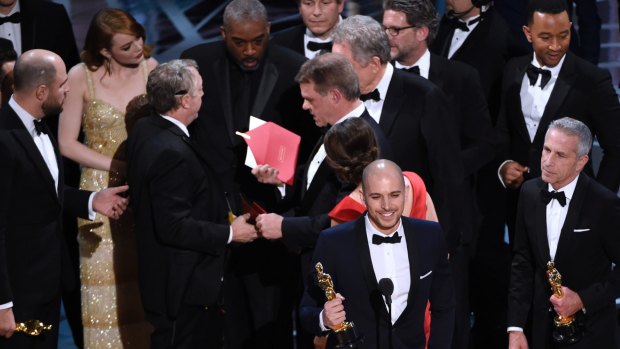 One of the PwC accountants, Brian Cullinan, centre, after handing the wrong envelope to Warren Beatty.