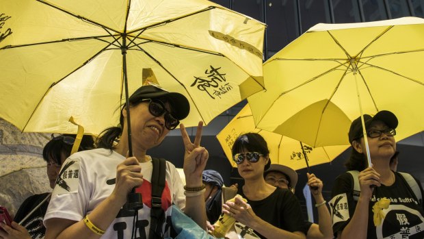 Pro-democracy protesters holding yellow umbrellas outside Hong Kong's Legislative Council building in June 2015.