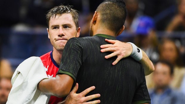 Abrupt ending: Illya Marchenko and Kyrgios embrace after the Australian retires.