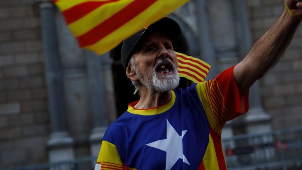 A Catalonia independence supporter wearing the Estelada flag stamped on his t-shirt in Barcelona in October.