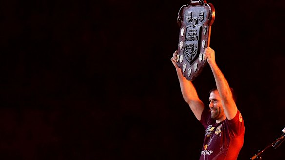 Cameron Smith of the Maroons holds up the winners' shield last year.