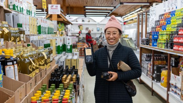 Chae buying olive oil at Mediterranean Wholesalers.