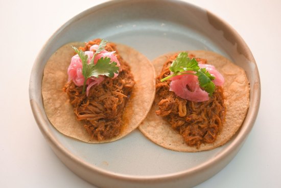 Pork tacos come in pairs.