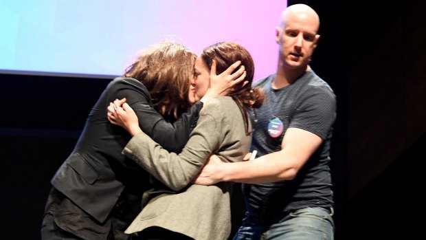 Security confronts protesters who kissed on stage after gatecrashing a Coalition for Marriage launch in Melbourne.