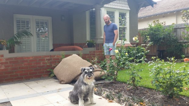 Mitford St, Elwood resident Stuart Brown with his dog, Billy. Water has damaged the floor boards and got into carpets. 
