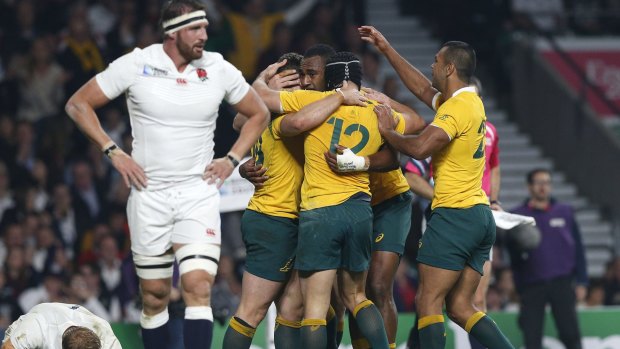 Chariot swinging low: Australian players celebrate as England are left to ponder what went wrong. 