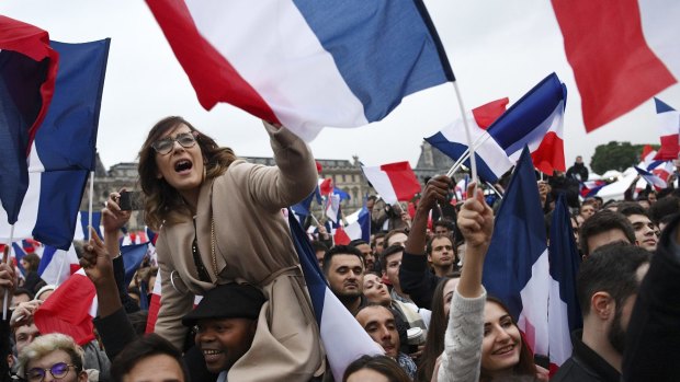 Supporters celebrate after Emmanuel Macron is victorious.