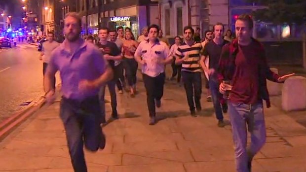 A man holds his beer while people flee terror attacks in London on Saturday. 