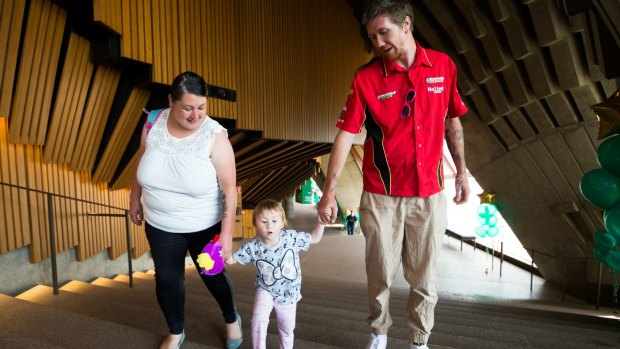 Shaun Birmingham and Jasmine Solis, with their daughter Nevaeh in the Sydney Opera House.
