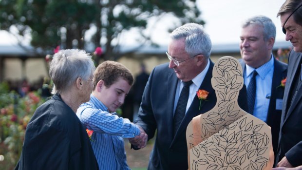 Health Minister Brad Hazzard shaking hands with Cooper Hodges, the grandson of Mrs Ingram, at the opening of Woronora's Wonderfully Made Memorial. 