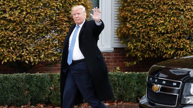 President-elect Donald Trump waves as he arrives at the Trump National Golf Club Bedminster clubhouse in Bedminster, New Jersey. 