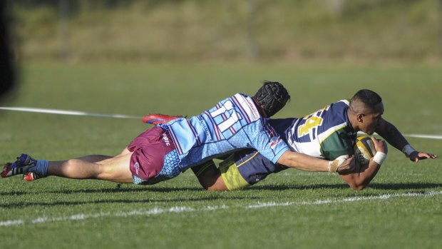 Owls winger Yeti Tago scores a try despite the efforts of Wests Kuti Maia Tahau. 