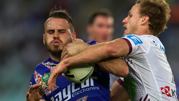Bulldogs hero: Josh Reynolds is tackled by Manly's Daly Cherry-Evans. 