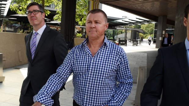 Former trade union boss Dave Hanna (centre) leaves the Magistrates Court during royal commission hearings.