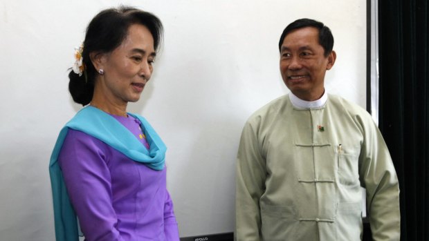 Myanmar's opposition leader Aung San Suu Kyi stands next to parliament speaker Shwe Mann in 2013.
