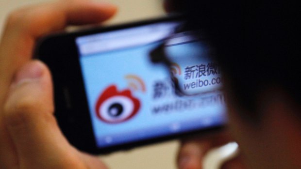 A user utilises a smartphone to visit the Sina Weibo microblogging site in China.
