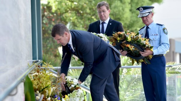 Then premier, Mike Baird, Police Minister Troy Grant, and Police Commissioner Andrew Scipione lay flowers in memory of NSW Police accountant Curtis Cheng.