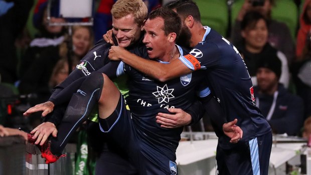 Top dogs: Luke Wilkshire celebrates his winning goal as Sydney FC leapfrogged City at the summit of the A-League.