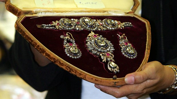 An officer of the Presidential Commission on Good Government (PCGG) shows diamond-studded items then valued at $US1.4 million during presentation of flamboyant former Philippine first lady Imelda Marcos' seized jewellery in Manila, in 2005.