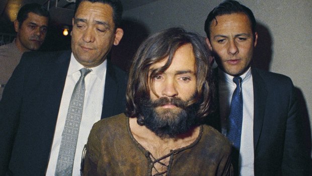Charles Manson pictured in 1969 being escorted to his arraignment on conspiracy to murder charges.