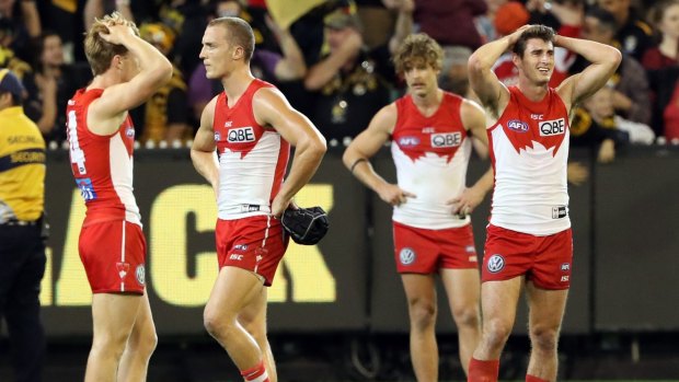 Disappointment: The Swans after their loss to the Tigers.
