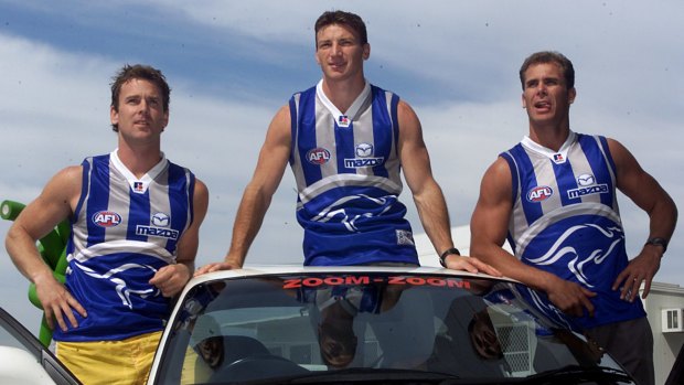 Simpson (left) in his playing days with Kangaroos teammates Brent Harvey and Carey.