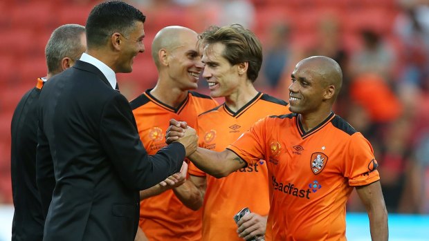 Roar coach John Aloisi and Henrique celebrate an A-League win this year. The club has announced interim CEO David Pourre will fill the role on a permanent basis.