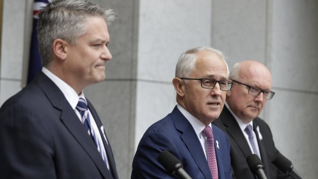 Prime Minister Malcolm Turnbull, flanked by Finance Minister Mathias Cormann and Attorney-General George Brandis, announces the proposed laws on Tuesday.